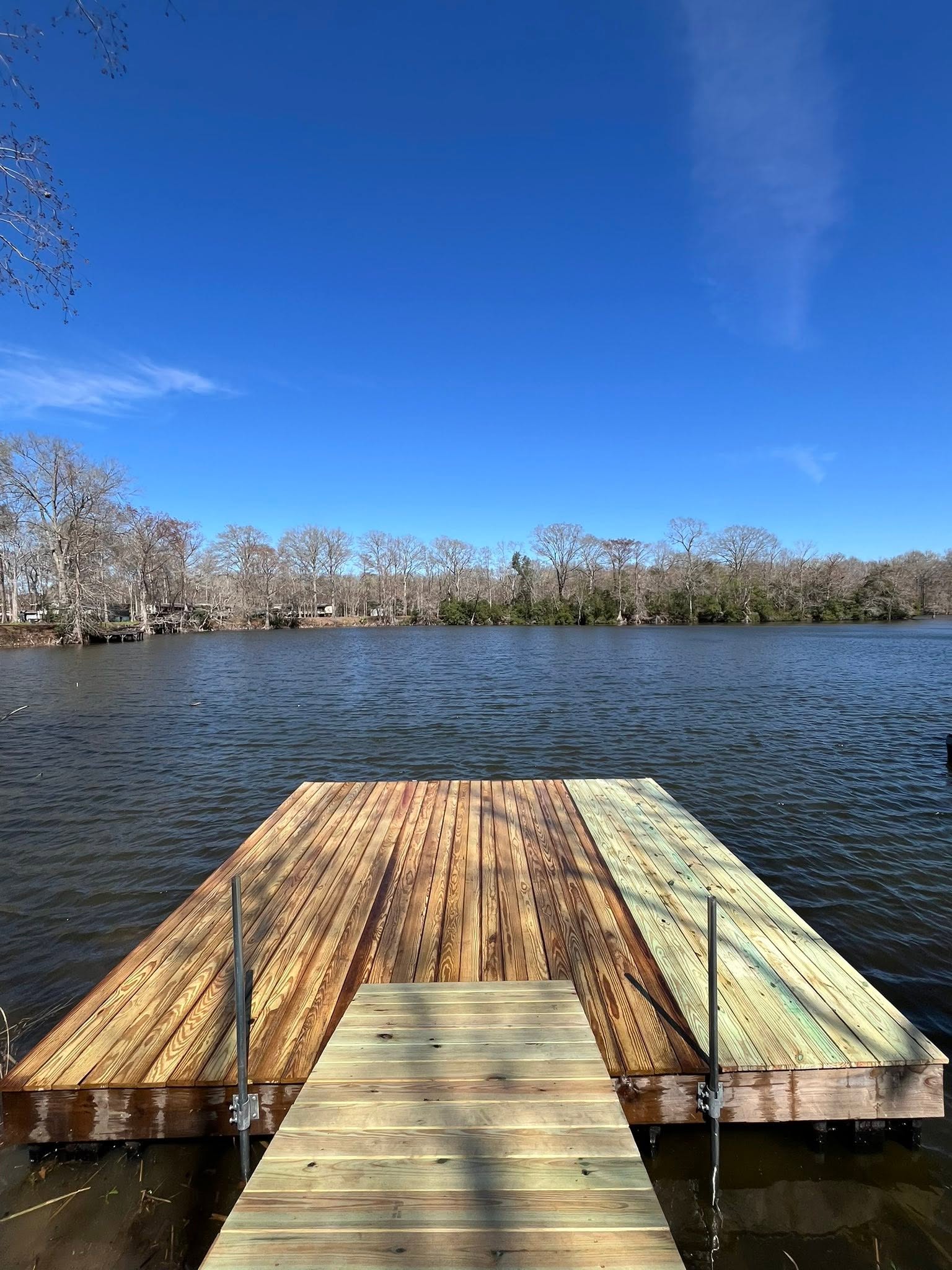 Timber dock walkway extending toward open water